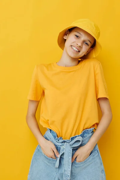 Attractive woman in a yellow hat Youth style casual wear yellow background — Stock Photo, Image