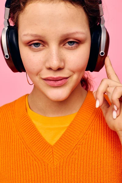 Retrato de una joven mujer mueca auriculares entretenimiento emociones música rosa fondo inalterado — Foto de Stock