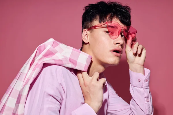 Молодий чоловік в рожевих окулярах рожевий блейзер позує студію рожевий фон незмінним — стокове фото