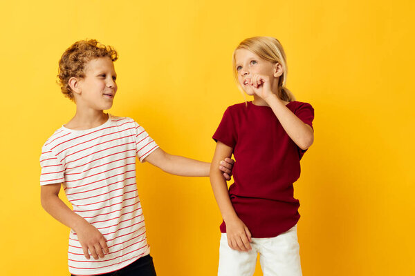 picture of positive boy and girl casual wear games fun together on colored background