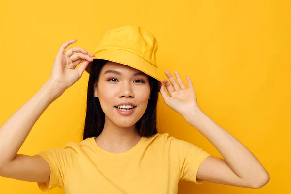 Porträtt asiatisk vacker ung kvinna bär en gul hatt poserar känslor gul bakgrund oförändrad — Stockfoto