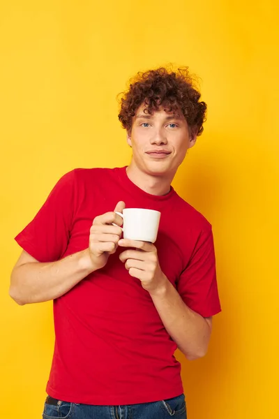 Cute red-haired guy posing with a white mug and in the hands of a drink Lifestyle unaltered — Stock Photo, Image