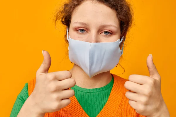 Beautiful woman in a yellow t-shirt medical mask protection cropped view unaltered — 图库照片