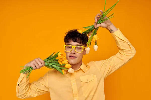 Handsome guy give flowers wear spectacles yellow shirt isolated background unaltered — Φωτογραφία Αρχείου