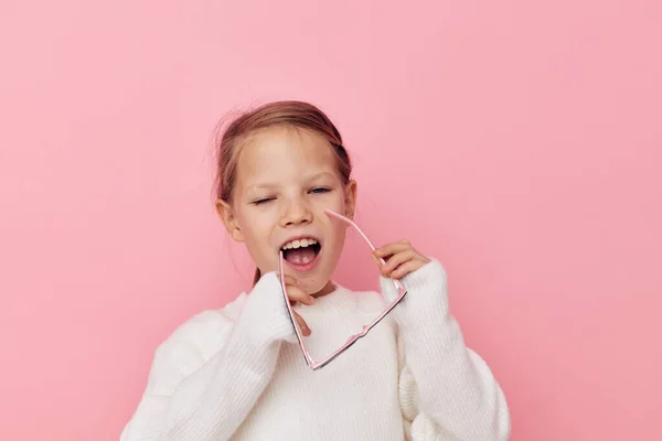 Retrato de niña feliz sonriente en un suéter blanco y gafas de fondo aislado — Foto de Stock