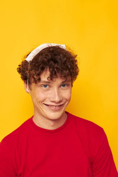 Cute red-haired guy wearing a red t-shirt medical mask on the face posing isolated background unaltered — Stock Photo, Image