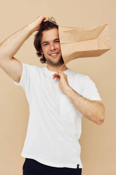 Man in een wit T-shirt met papieren zak Lifestyle ongewijzigd — Stockfoto