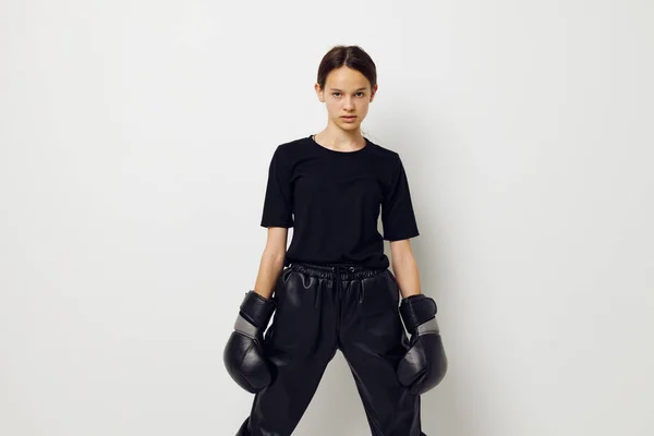 검은 색 스포츠 유니폼 권투 장갑을 끼고 외진 배경을 드러내는 운동 여자 — 스톡 사진