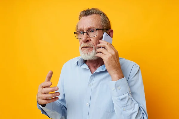 Portrait elderly man gray beard with glasses talking on the phone unaltered — Stock Photo, Image