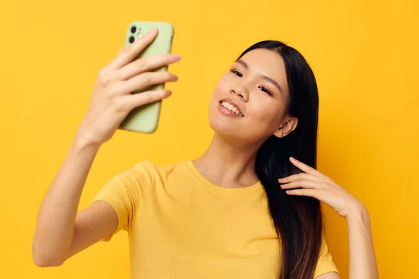 스마트폰을 들고 있는 아시아인아름다운 젊은 여성의 모습은 변하지 않은 삶의 방식 과 밀접 한 감정을 나누고 있다. — 스톡 사진