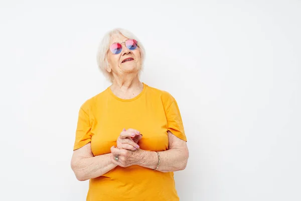 Photo of retired old lady happy lifestyle in yellow t-shirts close-up emotions — Stock Photo, Image