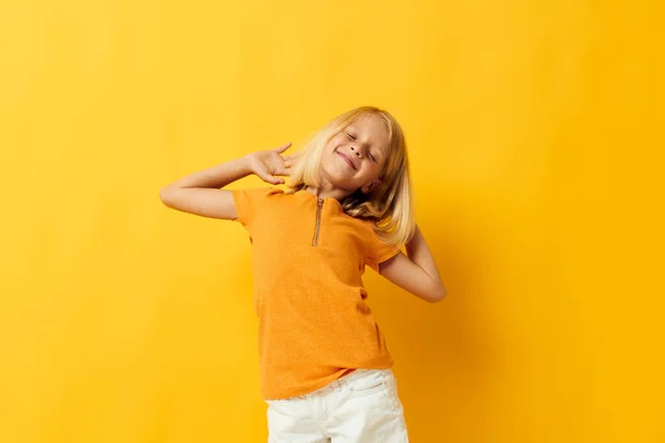 Little girl smile hand gestures posing casual wear fun yellow background unaltered — Stockfoto