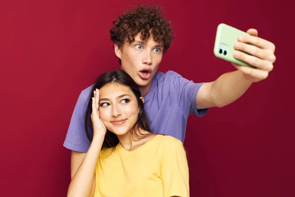 Agradable chico y chica tomar un selfie posando abrazo estilo juvenil — Foto de Stock