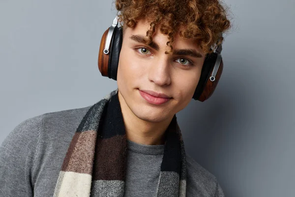 Handsome guy plaid scarf wireless headphones technology isolated background — Stock Photo, Image