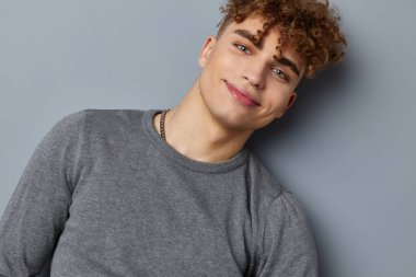 Gri sweatshirt 'lü şık bir adam. Moda stüdyosu izole edilmiş.