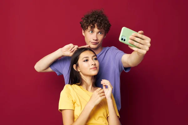 Nice guy and girl modern style emotions fun phone red background — Foto Stock