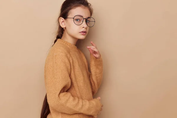 Cute girl in a sweater and posing glasses isolated background — Stock Photo, Image