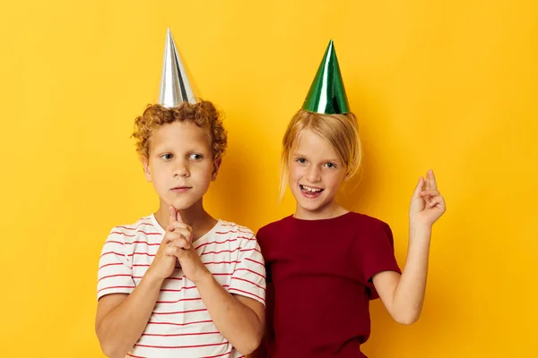 Foto van positieve jongen en meisje vakantie plezier met caps op je hoofd geïsoleerde achtergrond — Stockfoto