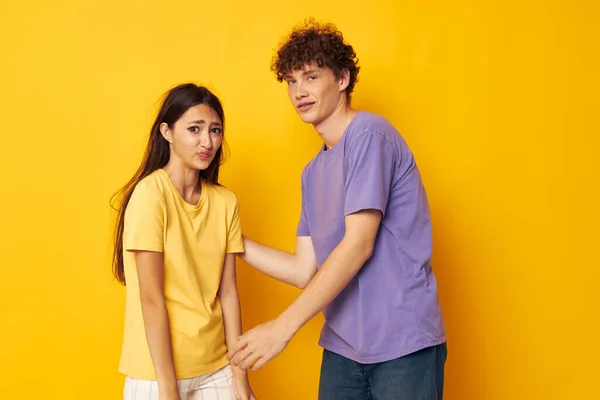 Jeune garçon et fille casual vêtements posant émotions antics fond jaune inchangé — Photo