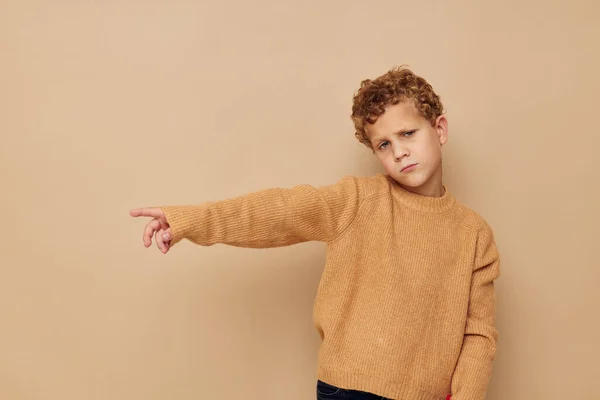 Curly boy in a beige sweater posing fun childhood unaltered — Photo