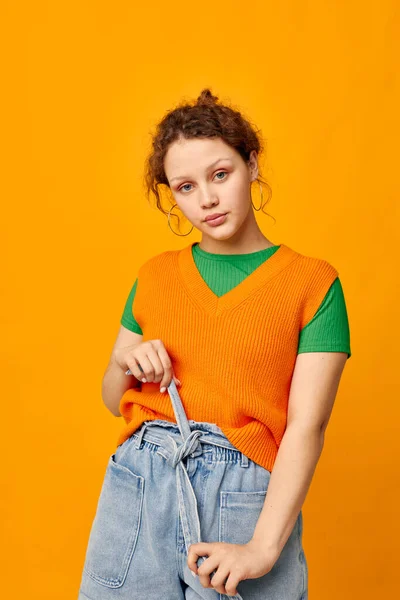 Young girl in orange sweater youth clothing posing isolated background — Stock Photo, Image