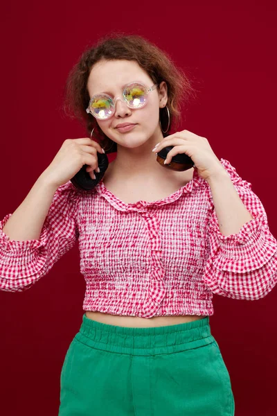 Portrait of a girl in green shorts glasses with diamond headphones posing — Fotografia de Stock