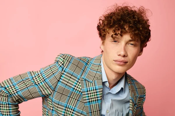 Portrait of a young curly man gesturing with his hands emotions checkered jacket Lifestyle unaltered — Stock fotografie