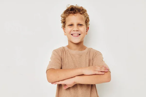 Cute little boy on a light background posing smile — Stock fotografie