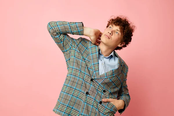 Portrait of a young curly man checkered blazer elegant style posing fashion pink background unaltered — Fotografia de Stock