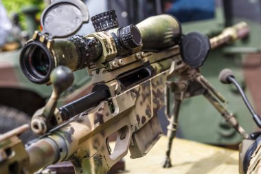 Modern powerful sniper rifle with a telescopic sight mounted on a bipod.Elements of the sniper rifle with tactical body . 