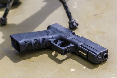 Pistol in holster on belt of an armed man.Multicam camouflage. Topic: weapon, armed man, gun, military patrol. Man in camouflage is armed with pistol