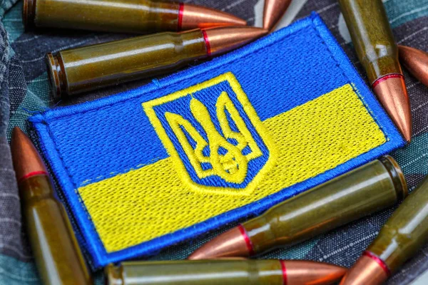 Fabric curved flag of Ukraine, UA. Blue and yellow colors.Ukraine patch on army uniform.Stop war.Patriotism.Concept of Ukraine.Democracy and politics. Close up shot, background