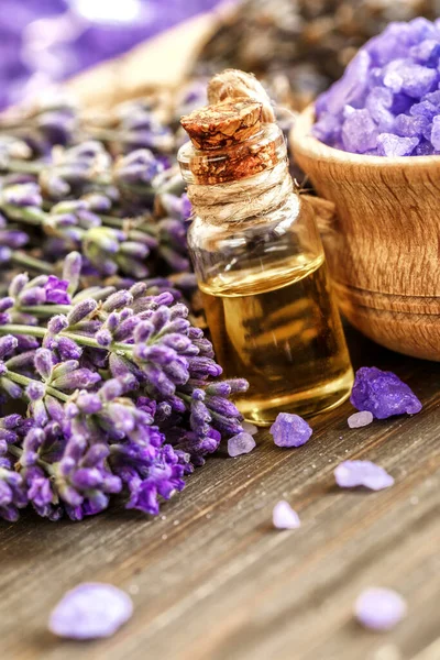 lavender\'s spa products with dried lavender flowers on a wooden table. Flat lay bath salt and massage oil on wooden background. Skin care, beauty treatment concept. Lavendula oleum