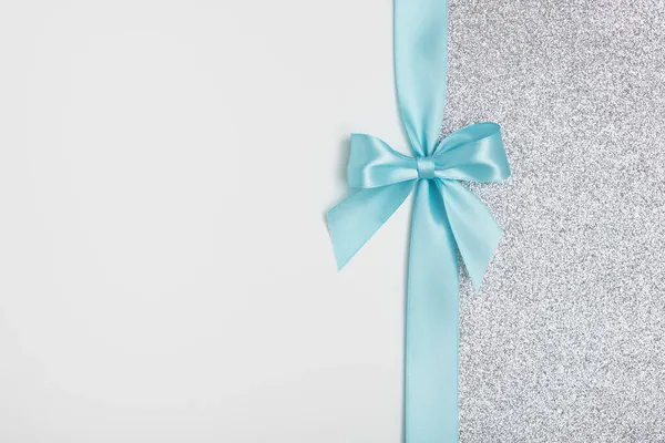 Shiny Blue Satin Ribbon Bow White Silver Sparkling Background Stock Image