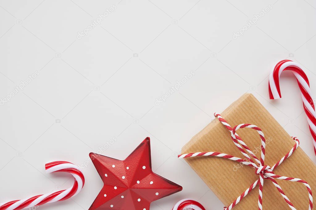Christmas corner border with gift, candies and ornament on white background