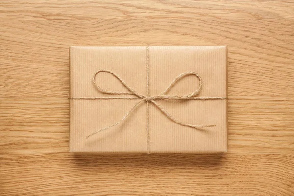 Small Gift Box Bow Wrapped Kraft Paper Wooden Table Stock Picture