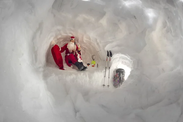 Santa Claus lives in a snow house - an ice cave in the mountains. A cozy room protects from snow storms, the grandfather leaves it to take a bag of gifts for New Year and Christmas