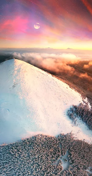 Mount Khomyak and Synyak in the Carpathians, the sun\'s rays at sunrise and sunset illuminate the landscape, fog, wild forests and alpine fields. Panorama 360 from a drone.