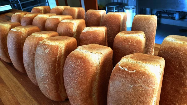 Tahta bir masada beyaz ekmek somunları