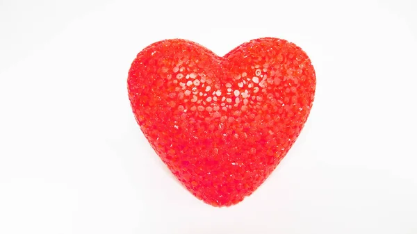 red plastic heart lamp on white background
