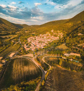 Panoramic drone view of one of the most beautiful French towns in southern France - Mirmande. Old historic town. Sunset over the surrounding mountains.