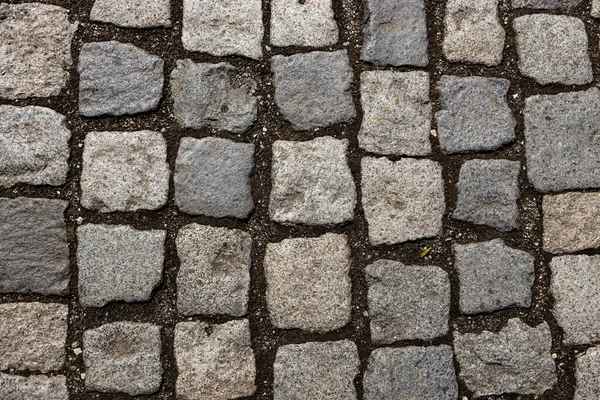 Mosaik av små marmorkuber. trottoarer och torg bildas av sten matta med rutor. Gamla kullerstenar Royaltyfria Stockbilder