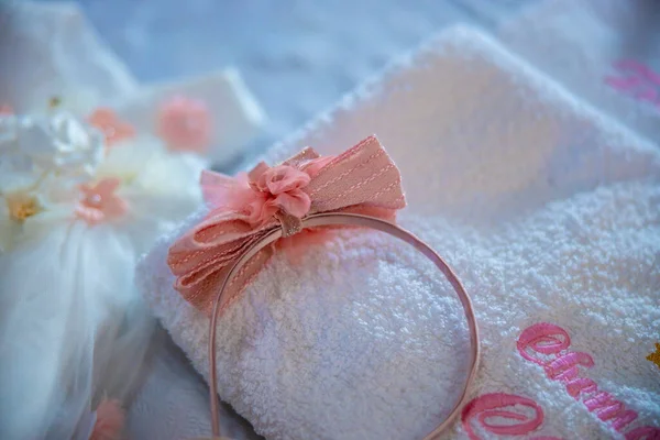 Baptism pictures. A pink baby girl tiara diadem for religious celebration after birth. High quality photo