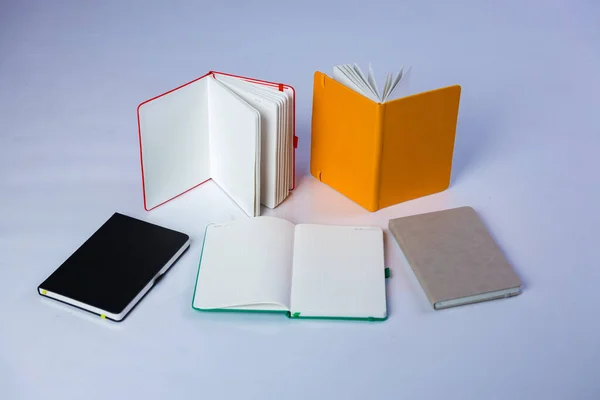 Colourful Journals Placed Open Closed Beautiful Studio Photo Notebooks Pens — Zdjęcie stockowe