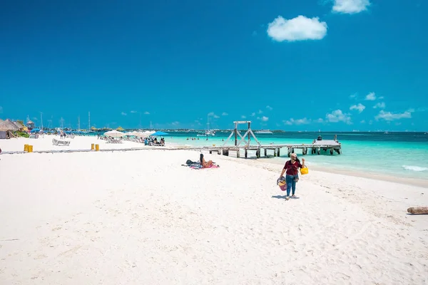 Liegestühle auf Sand am Strand mit Pier. Touristen beim Sonnenbaden genießen den Sommerurlaub — Stockfoto