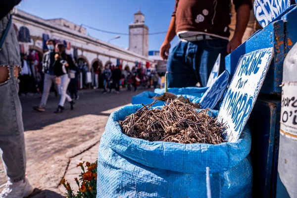 Closeup of dry roots in sack at market for sale on street on sunny day — Stock Photo, Image