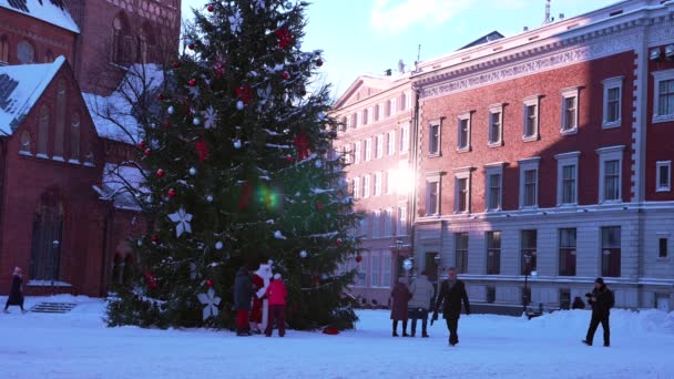 Kerstman wandelen door de enorme kerstboom in Riga, Letland. — Stockvideo