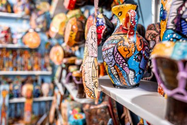 Hand painted decorative multicolored vase on shelf at retail shop