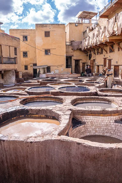 Dyed water fill in tanks in tannery against old residential building — Φωτογραφία Αρχείου