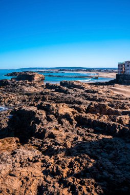 Rocky coastline and seascape against blue sky